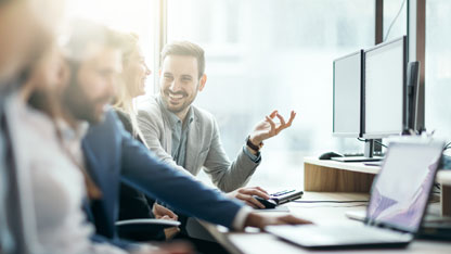 Happy office staff chatting