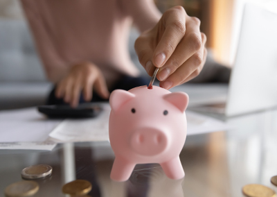 putting a coin in piggy bank