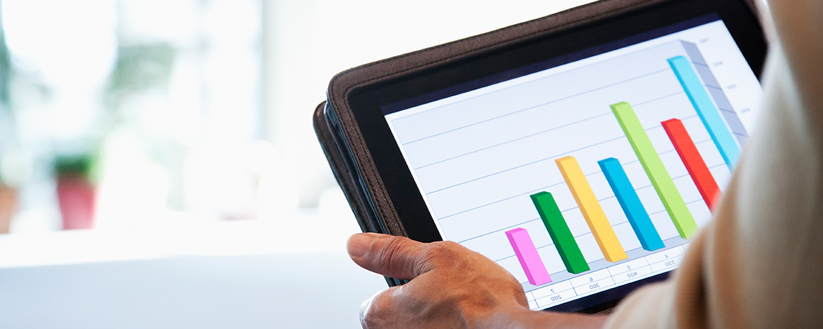 Person holding tablet with graph on it