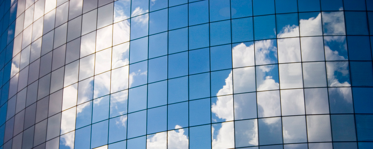 Office window with reflection of clouds